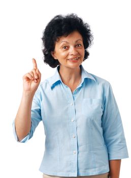 Portrait of a  happy senior woman pointing upwards on white. 