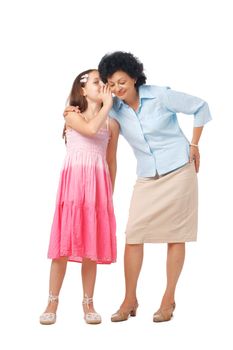 Grandmother and her grand daughter whispering something into her ear, full length.