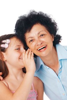 Close-up of a grandmother and her granddaughter whispering something fanny  into her ear.