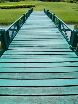 Green wooden bridge in garden