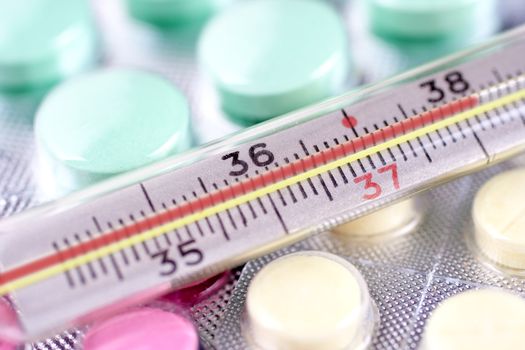 thermometer and pills as a background