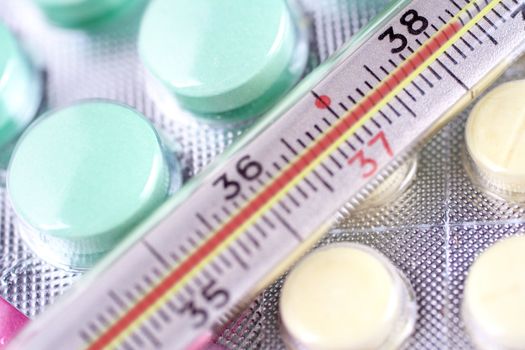 thermometer and pills as a background