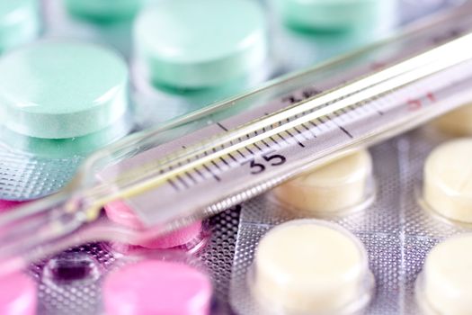 thermometer and pills as a background