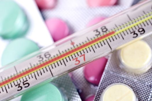 thermometer and pills as a background