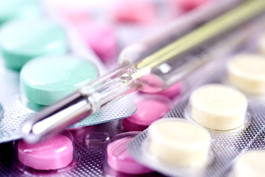 thermometer and pills as a background