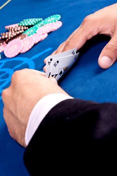 hands of a man with a card for the poker table