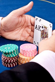 hands of a man with a card for the poker table