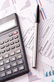 financial statement with calculator and pen