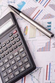 financial statement with calculator and pen