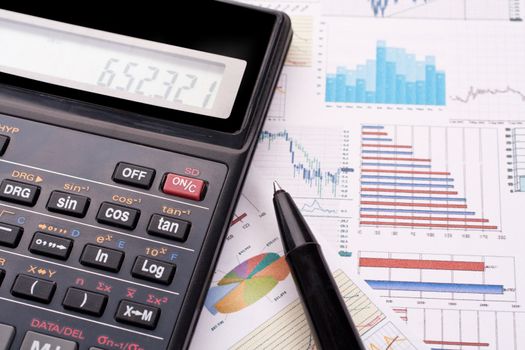 financial statement with calculator and pen