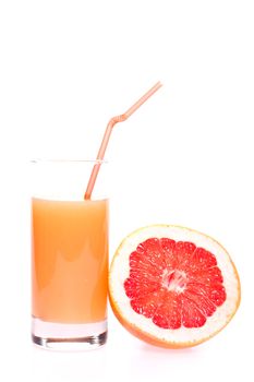 grapefruit and juice in glass on a white background