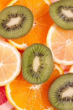 assorted fruits of apple, grapefruit, orange, lemon and kiwi as a background