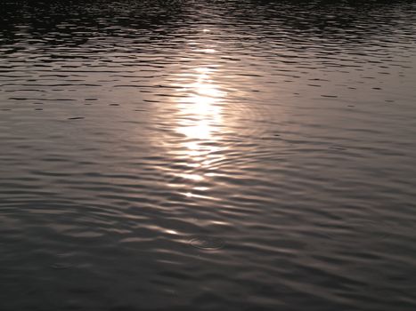 Abstract golden reflection on water with shapes texture
