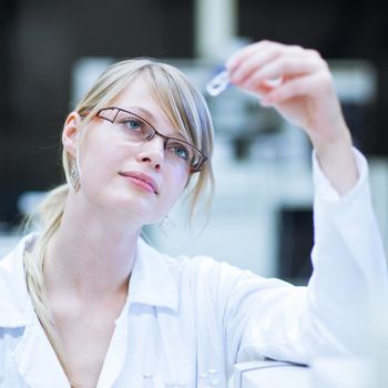 portrait of a female researcher carrying out research in a chemistry lab (color toned image; shallow DOF)