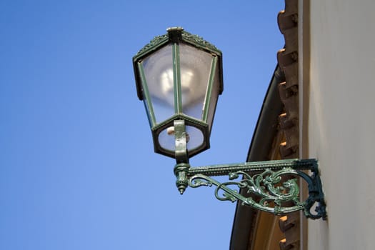 the lantern on the wall in the historic location in Prague