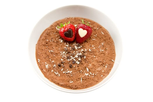 Picture of some chocolate mousse with strawberries with hearts inside them