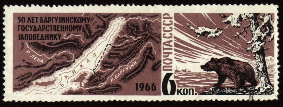 Postage stamp printed in USSR shows 50-year anniversary of Barguzinsky reserve on Baikal lake, map of Baikal region, bear on lake shore