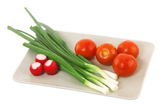 white plate with tomato, radish and green onion, vegetarian food