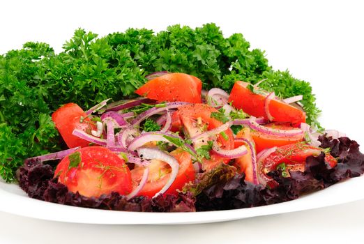 Salad of tomato with sharp blue onion and parsley on a white background