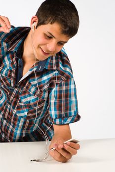 Teenager listening to music with his media player