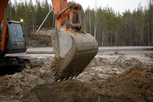 Crawler excavator working on the roadside