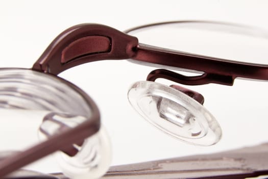 A  pair of  folded eye glasses on a white background