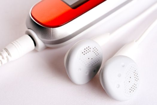 mp3 player with headphoneson on a white background