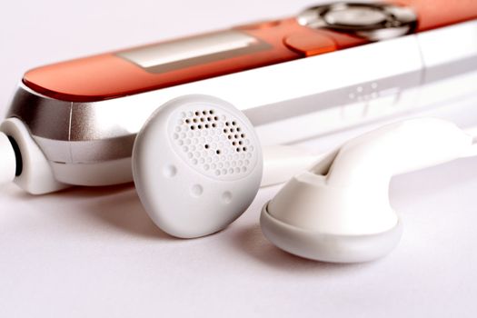 mp3 player with headphoneson on a white background