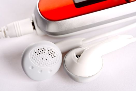 mp3 player with headphoneson on a white background