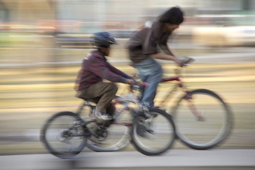 Two boys racing against eachother with their mountain bikes