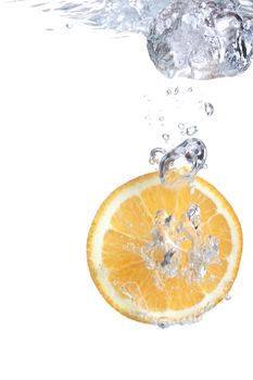 Orange falls into water on a white background