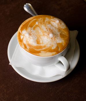 Cappuccino coffee cup closeup at the table