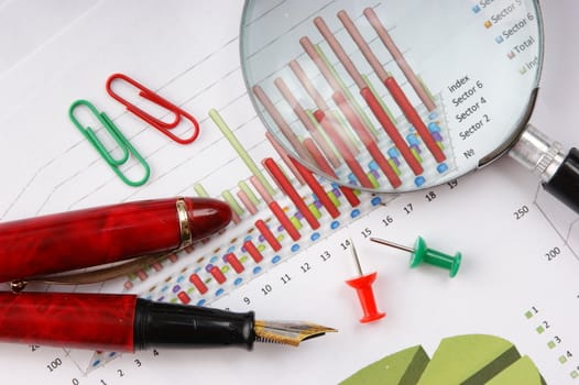 Graphs tables and documents laid on the table