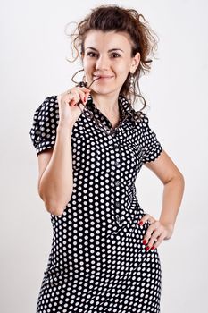 beautiful woman in a black polka dot dress with glasses