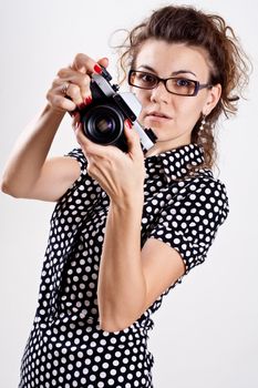 beautiful woman in a black polka dot dress with camera