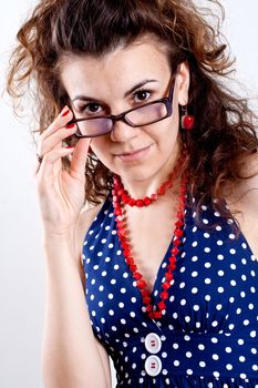 beautiful woman in a blue polka dot dress with glasses