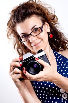 beautiful woman in a blue polka dot dress with camera