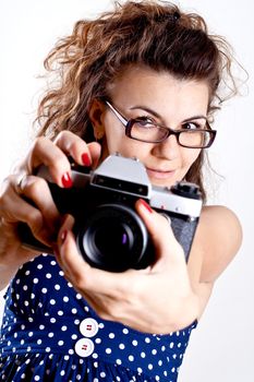 beautiful woman in a blue polka dot dress with camera