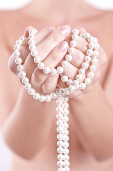 ornament of pearls in the women's hands