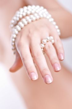 ornament of pearls in the women's hands