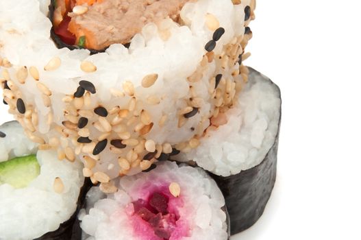 Close up on several fresh Maki Rolls arranged over white