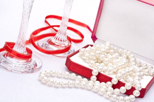 pearls in a red gift box with glasses