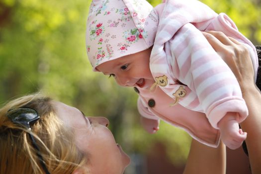 Happy mum and her child in park