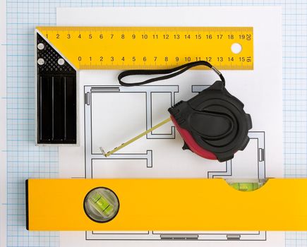 drawing at home with construction tools on a background of graph paper