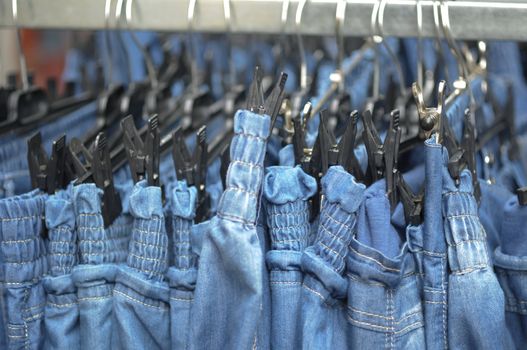 Row of jeans trousers on sell