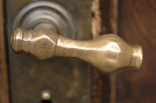 Ancient brass door handle on wood door