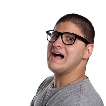 A goofy man wearing trendy nerd glasses isolated over white with a funny scared expression on his face.