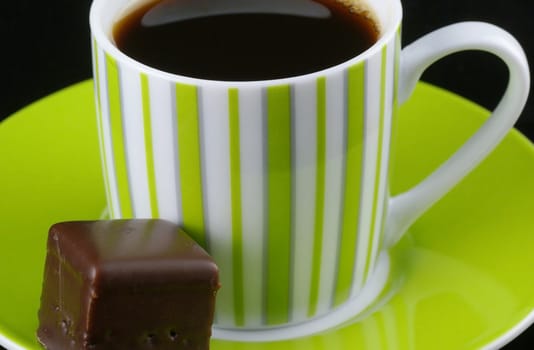 Cup of coffee with a chocolate.