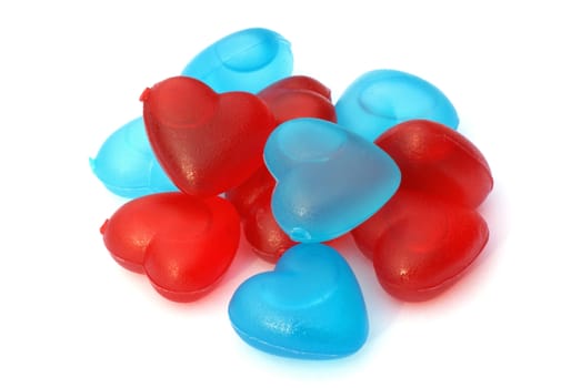 Red and blue heart shaped ice cubes, isolated on a white background.