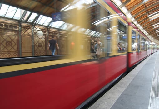 Berlin subway platform with passengers reflection
